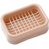 A light pink double layer drain soap dish with a grid pattern for draining water.