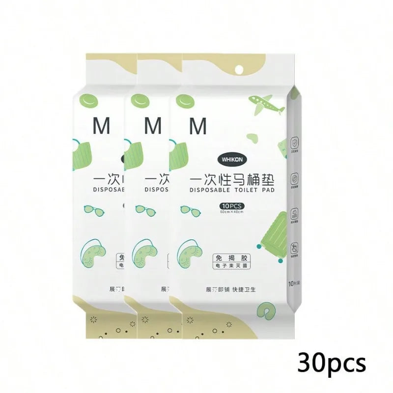 A set of disposable toilet seat covers in green and white packaging.