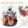 A hand holds a glass spice jar filled with reddish-brown spices, next to a set of rotating spice jars.