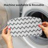 Hands holding a gray and white textured microfiber pad for a machine washable and reusable mop.