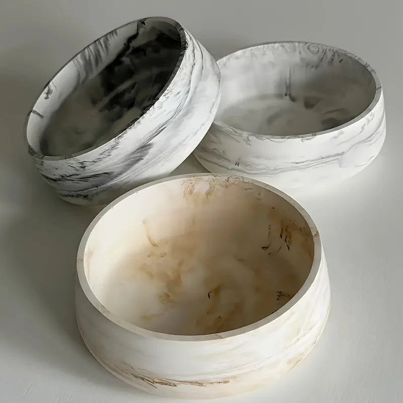 Three white silicone resin molds with marbled gray patterns for baking and crafts
