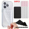 A clear silicone suction cup phone stand with multiple silicone suction cups and a black silicone grip shown next to a smartp