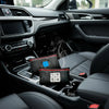 A set of reusable silica gel dehumidifier bags resting in the center console of a car interior.