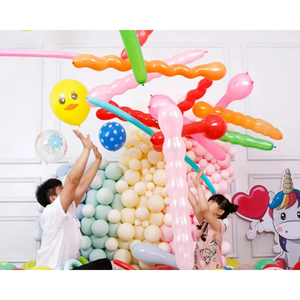 A colorful set of inflatable cartoon animal balloons, including yellow, pink, orange, and green shapes, are floating in the a
