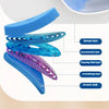 Set of five layers of blue and purple cleaning sponges and a scratch cloth on a wall-mounted toilet brush.