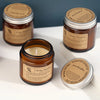 Three jars of Aroma Sensation scented soy wax candles in brown glass cups displayed on a white surface.