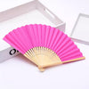 Ventilateur pliable rose et or à main, fait de bambou et de papier