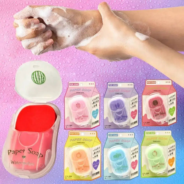 A hand is lathering with white soap, next to various packages of paper soap sheets for travel.