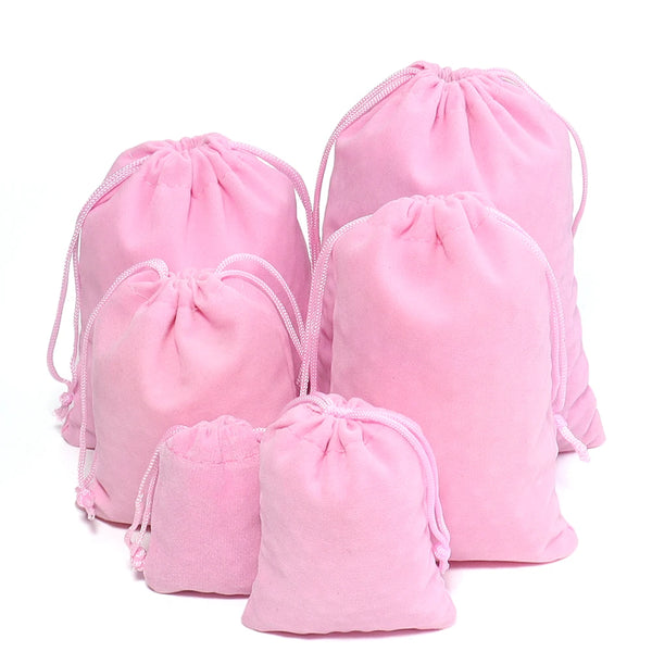 Four pink velvet drawstring jewelry bags are displayed against a white background.