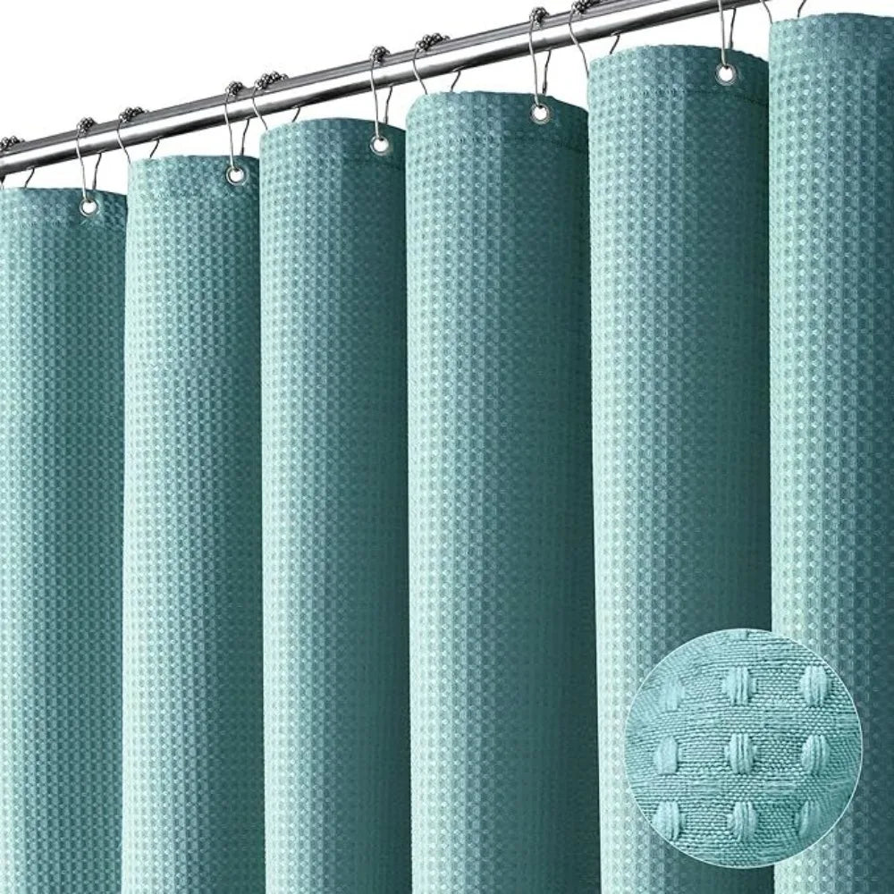 A set of vertical, ribbed shower curtains in a muted teal color hanging from a metal rod.