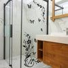 Decorative flower butterfly wall stickers on a glass shower enclosure and bathroom vanity