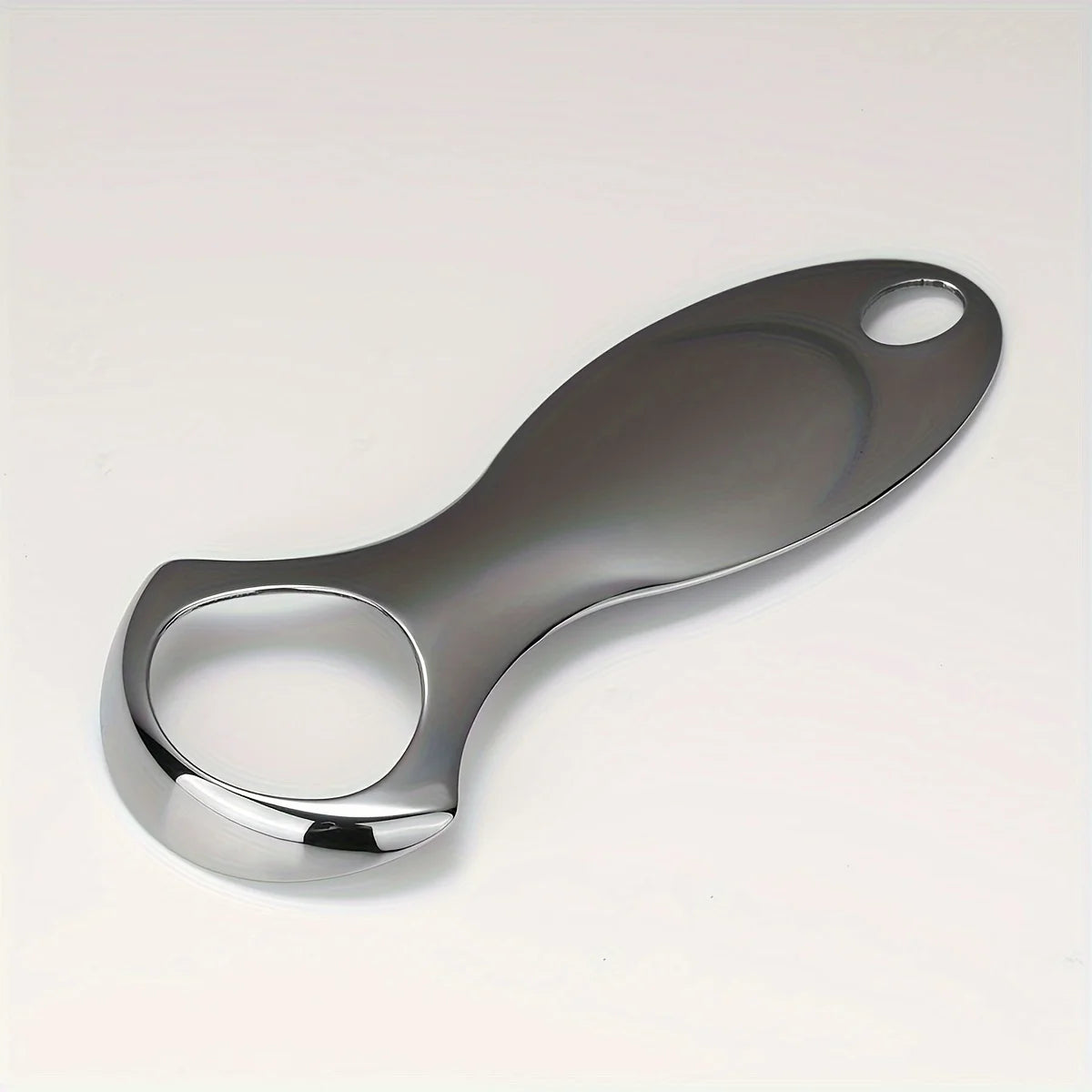 A stainless steel tongue scraper with a protective case shown against a white background.