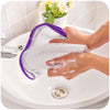 Mains utilisant un coussin de protection anti-chaleur violet pour repasser sur un évier en céramique blanche.