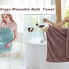 A woman models a pink bath towel draped over her shoulder, showcasing the wearable bath towel product.