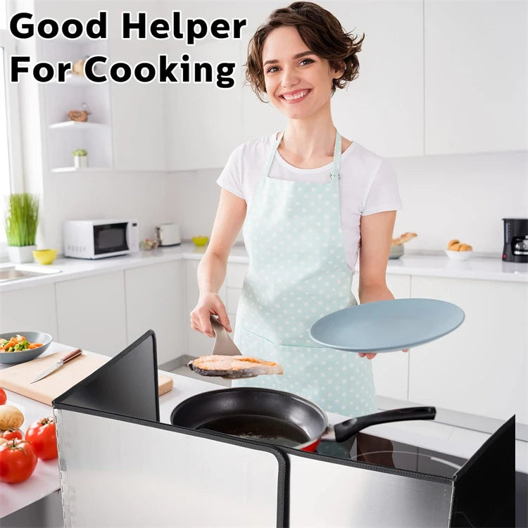A woman wearing an apron is preparing food on a stovetop with a foldable stainless steel oil splash guard.