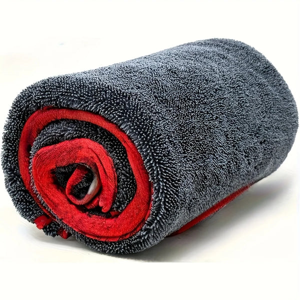 A rolled grey microfiber car drying towel with a red accent, showing its texture and compact form.
