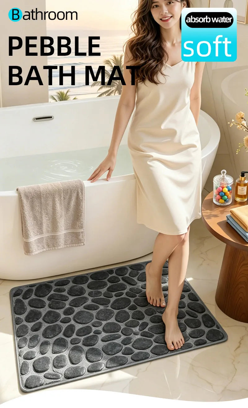 A woman stands beside a bathtub with a pebble bath mat placed on the floor.