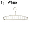 A single white foldable multi-hole space-saving laundry drying rack.