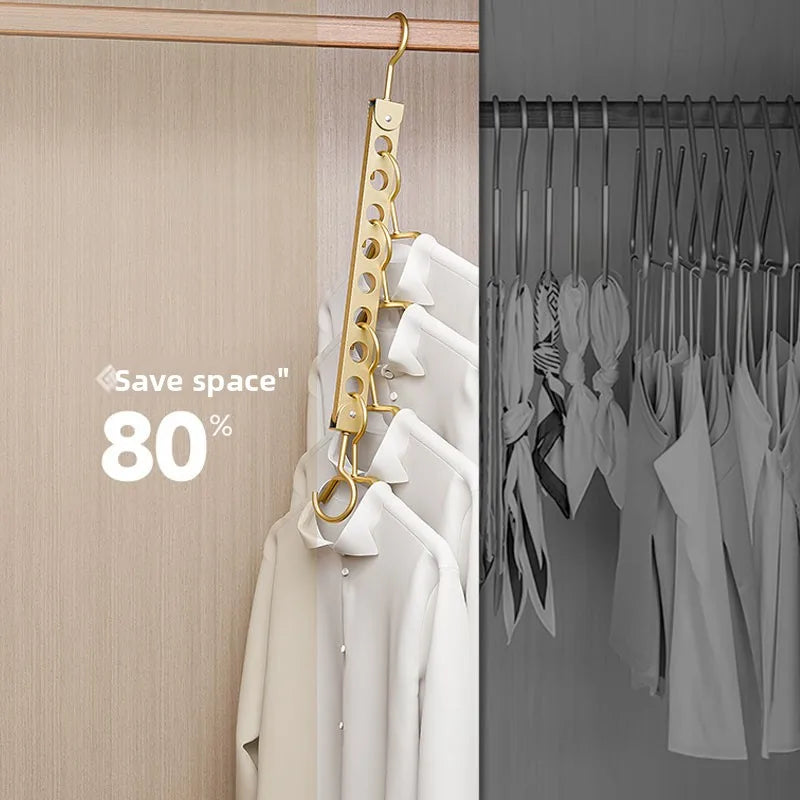 A close-up of a gold-colored foldable storage rack for clothes hangers mounted on a closet door.