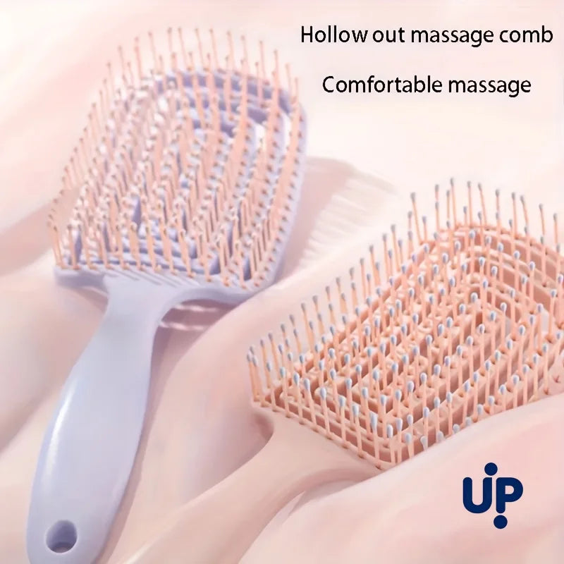 A light pink volumizing detangling hair massage comb is shown with a silicone handle and multiple bristles on a white backgro