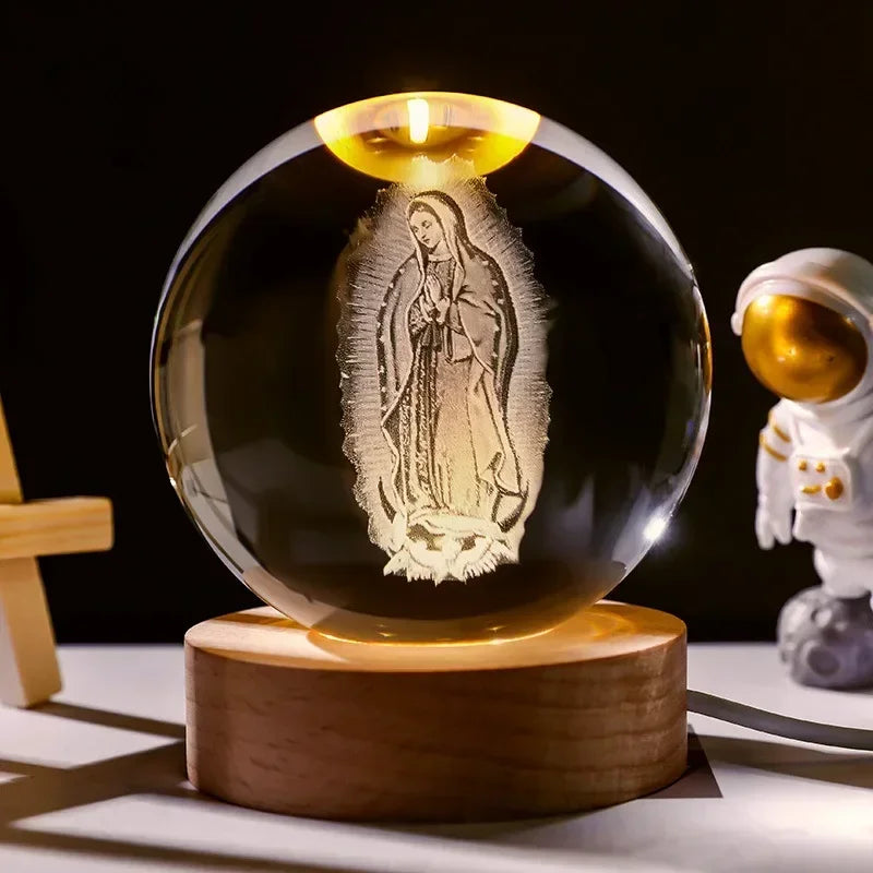 A glass orb containing a figure of the Virgin Mary is displayed on a wooden base.