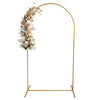 A gold arch stand decorated with white and peach floral arrangements for party or event decor.