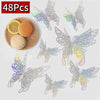 48 pieces of iridescent decorative butterfly wall stickers displayed next to a slice of lemon and an orange.