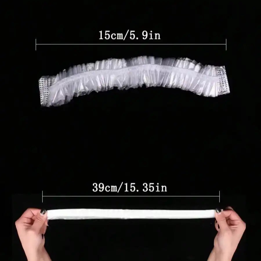 A transparent disposable shower cap is shown, measuring 15cm or 5.9 inches.