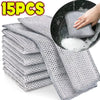 A stack of 15 pieces of gray thickened metal wire cleaning cloths being used in a black bowl.