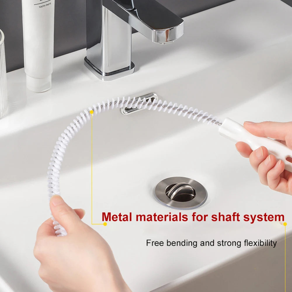 A hand is demonstrating a flexible metal brush for drain cleaning, highlighting its bending and flexibility.