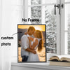 A custom photo canvas print of a couple embracing is displayed on a windowsill.