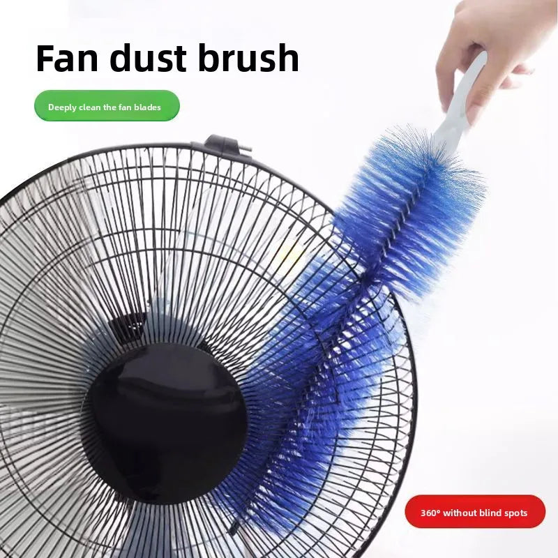 A hand is using a blue fan dust brush to clean the blades of a ceiling fan.