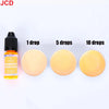 A bottle of fluorescent golden yellow liquid candle dye next to three round discs showing 1, 5, and 10 drops of the color.