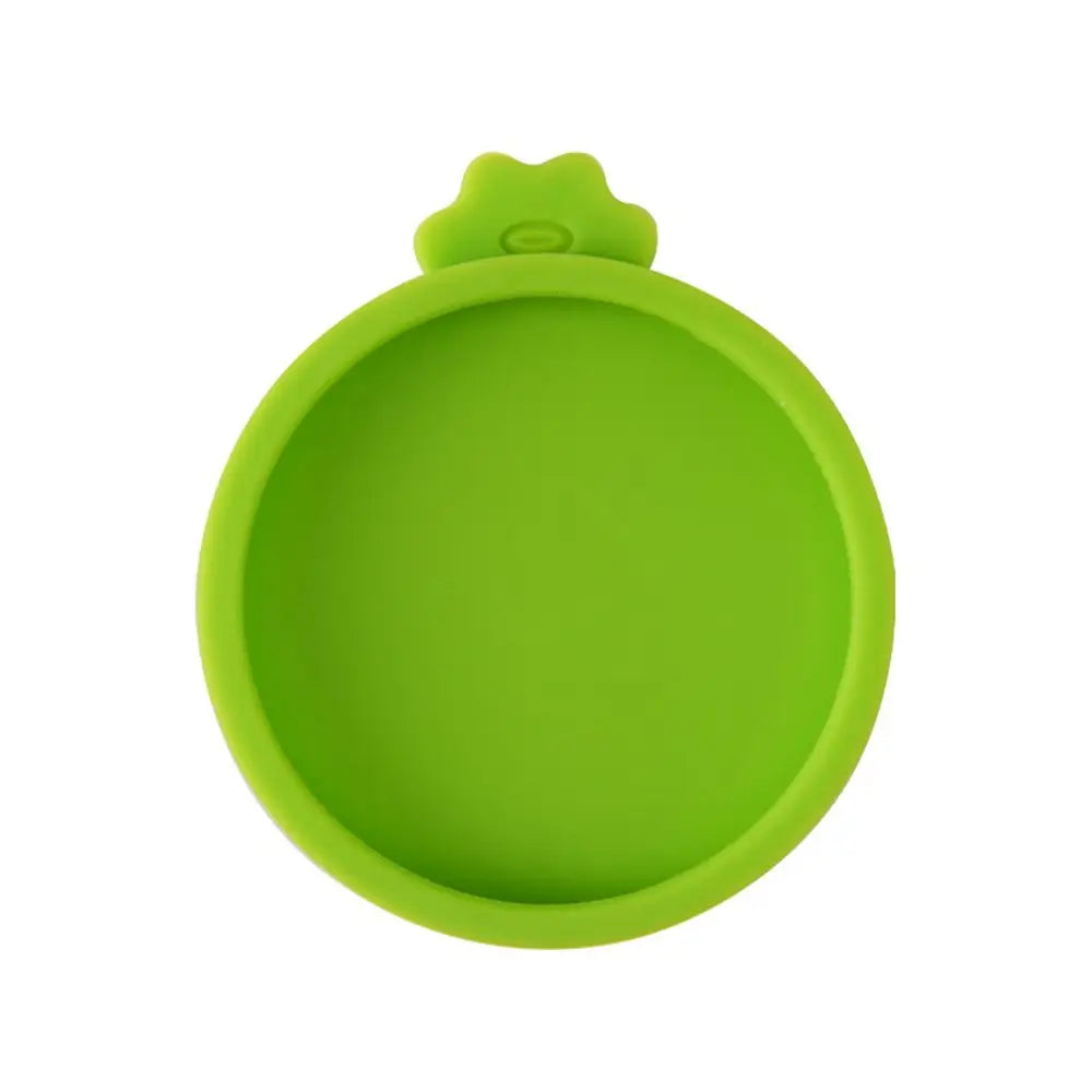A bright lime green silicone reusable food storage lid or cover.