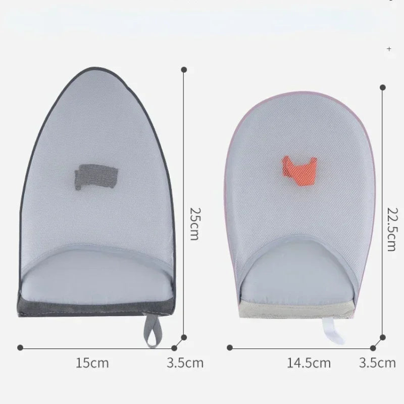 A portable ironing board with a padded surface and a small orange element, shown in a side view.