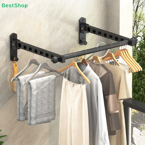 A black wall-mounted foldable clothes drying rack with wooden hangers is displayed on a light-colored wall.