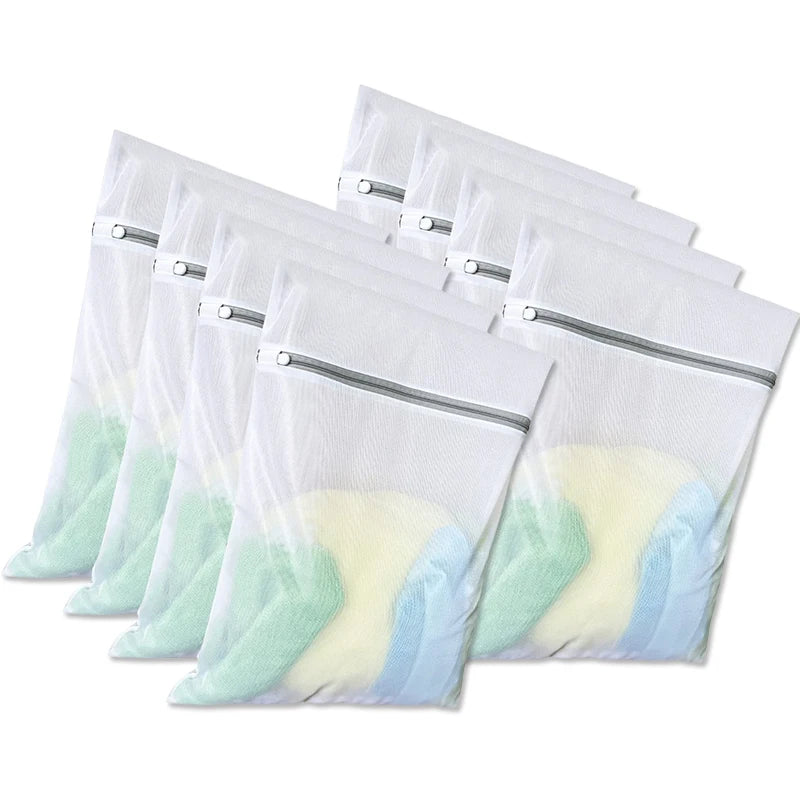 A stack of clear mesh laundry bags with zippers in white, light green, and pale yellow colors.