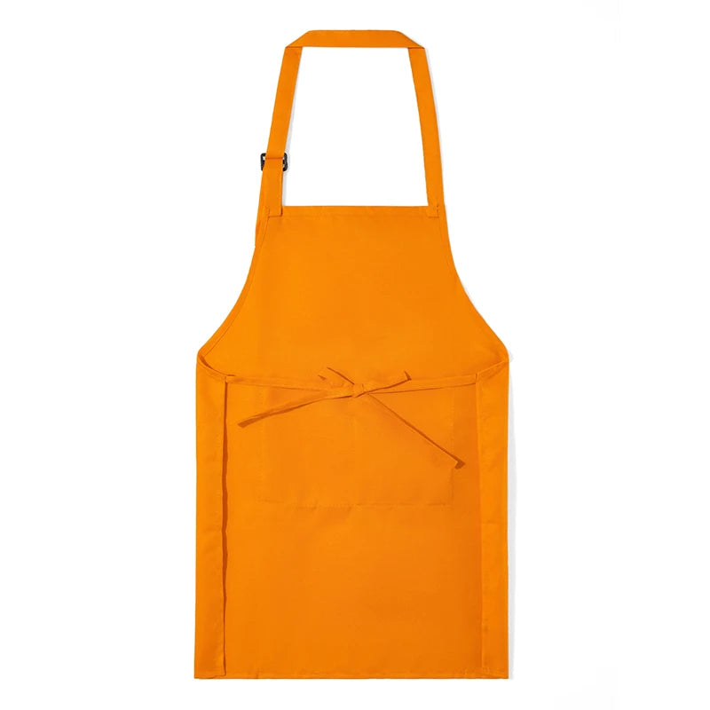 A bright orange kids adjustable apron and chef hat set hanging against a white background.