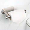 A silver wall mounted toilet paper holder with a white roll of toilet paper on a white marble surface.