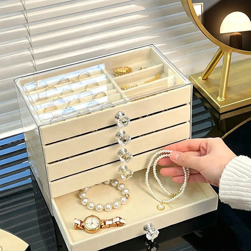 A hand is placing a pearl necklace into a white acrylic 5-tier desktop jewelry organizer rack.