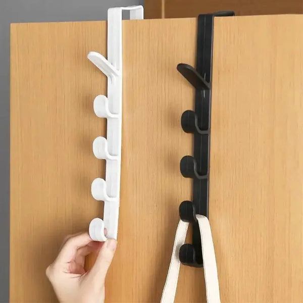 A hand is installing a versatile door hook rack for closet storage onto a wooden door.