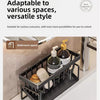 A black kitchen sponge holder and drain rack with a hanging hook placed on a bathroom countertop.
