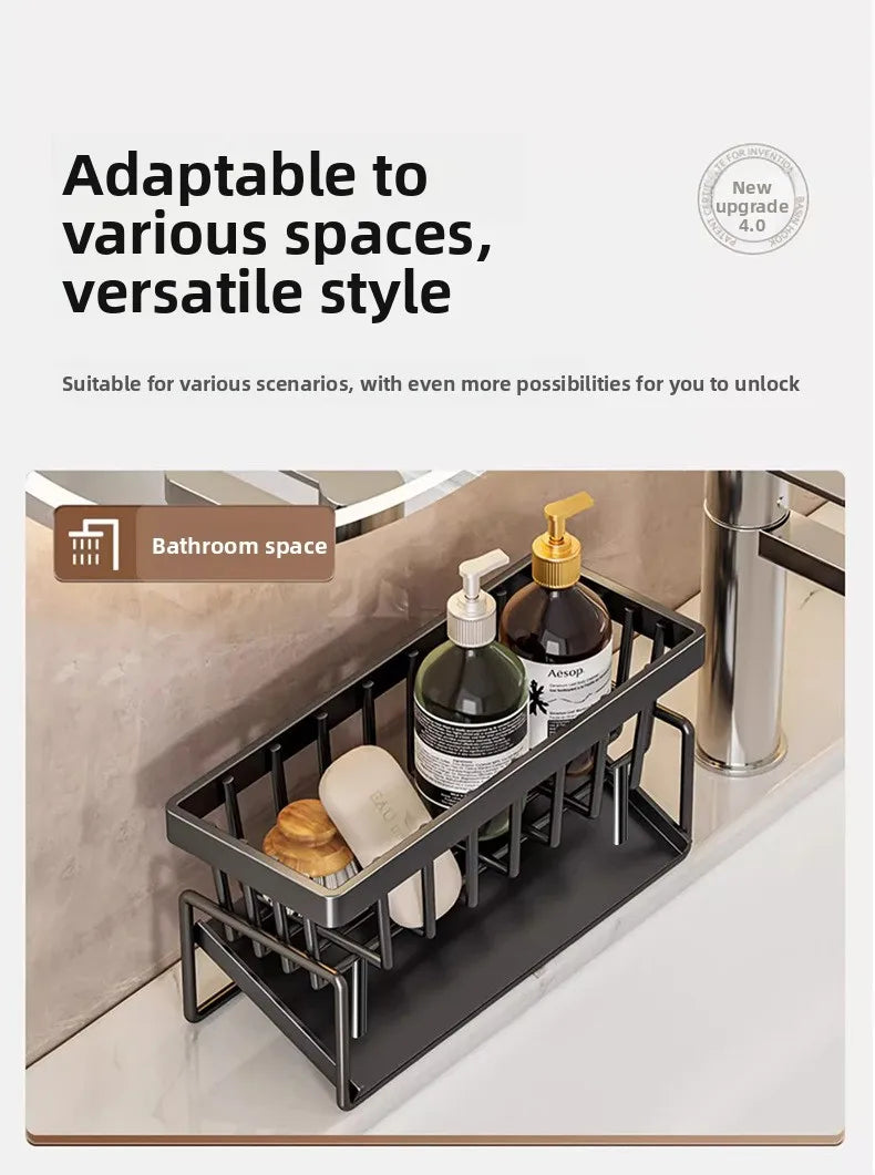 A black kitchen sponge holder and drain rack with a hanging hook placed on a bathroom countertop.