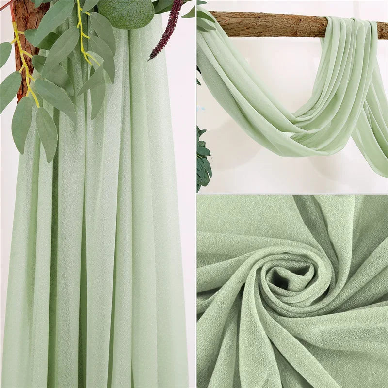 Light sage green sheer chiffon fabric draped vertically and folded into a swirl.