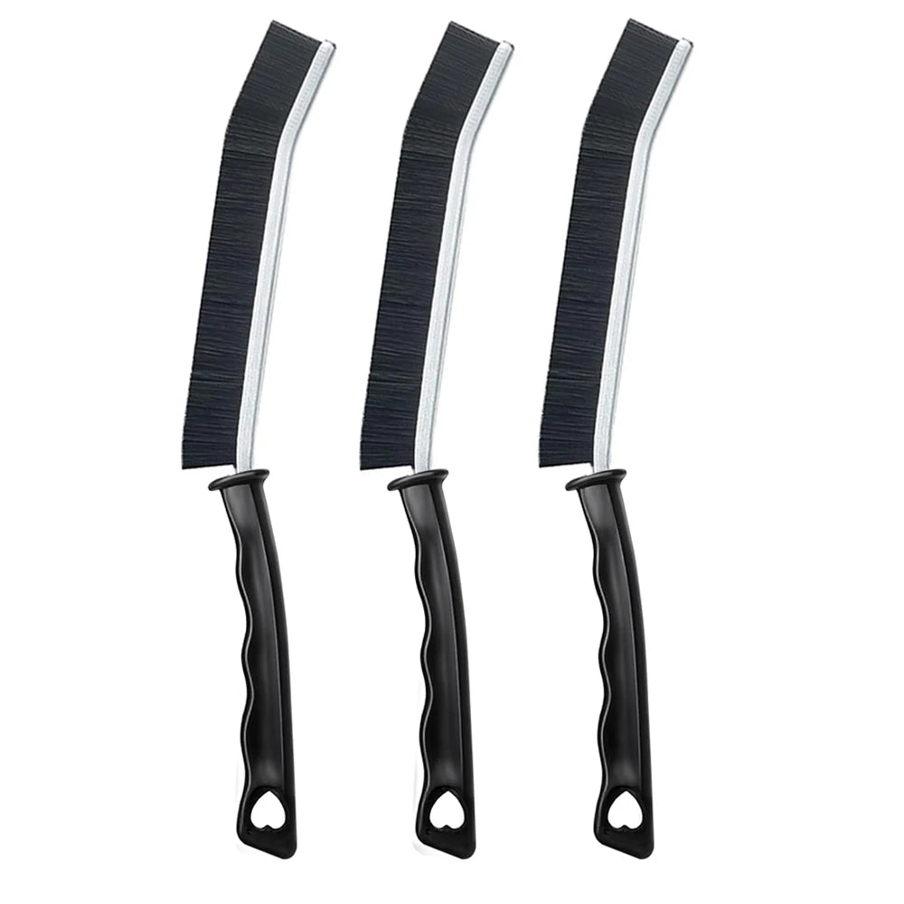 A set of three black and silver crevice cleaning brushes for tight spaces