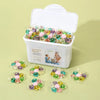 A white container filled with colorful laundry beads for stain removal and freshness.