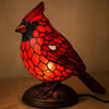 A decorative resin bird table lamp shaped like a red bird with intricate scale patterns.