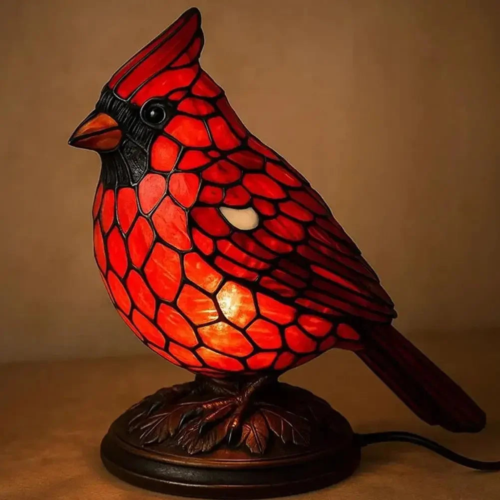 A decorative resin bird table lamp shaped like a red bird with intricate scale patterns.