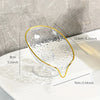 Clear oval plastic soap dish with a gold rim and drainage holes shown on a white surface.