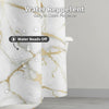 Close-up of a white and gold marble design shower curtain showing water beads off the fabric.